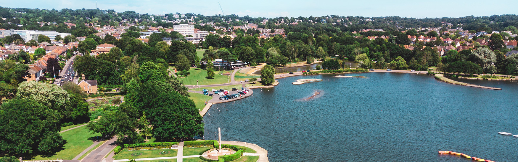 Drone shot overlooking Poole park and the lake 